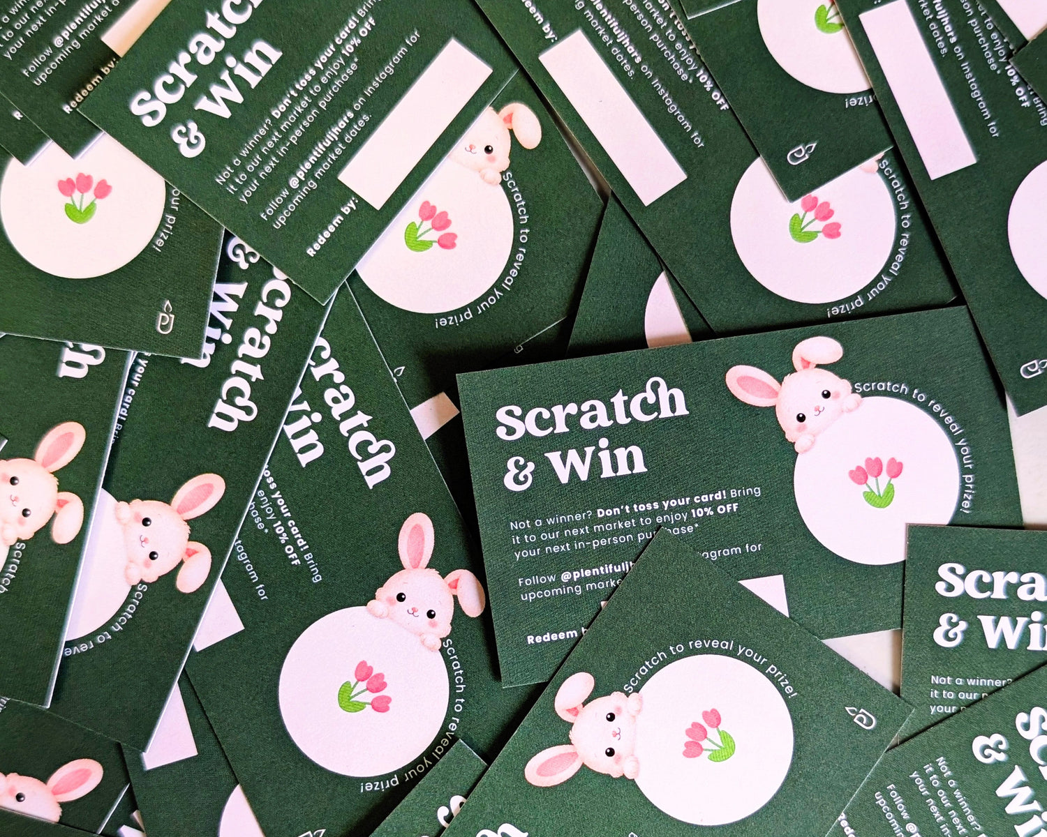 Multiple green scratch and win cards with a rabbit illustration on a green background